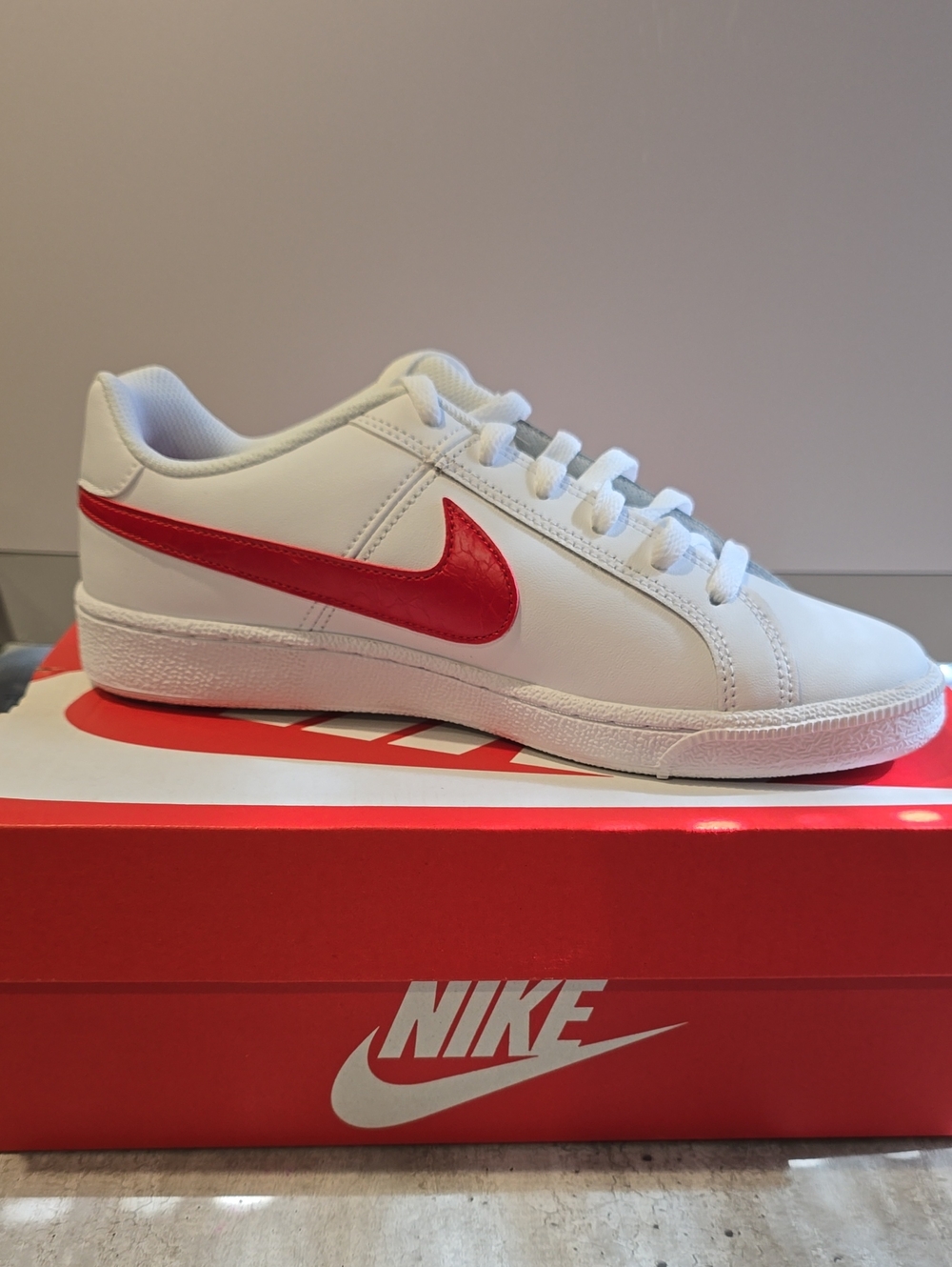 Nike White Low-Top Sneaker with Red Swoosh